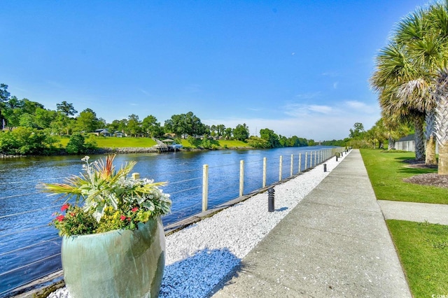 dock area with a water view and a lawn