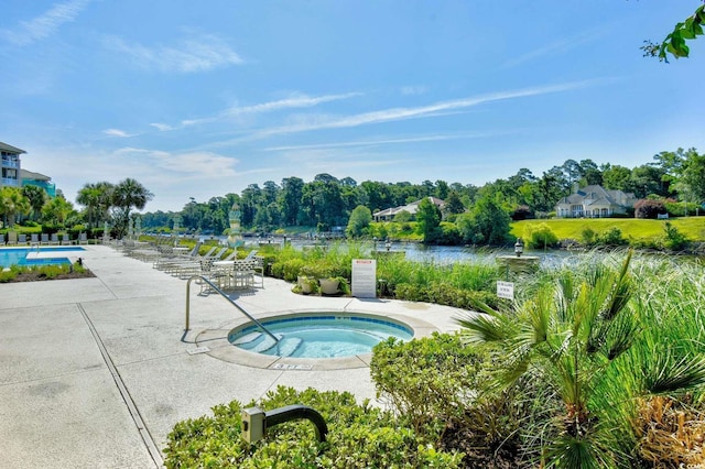 community pool featuring a patio area and a hot tub