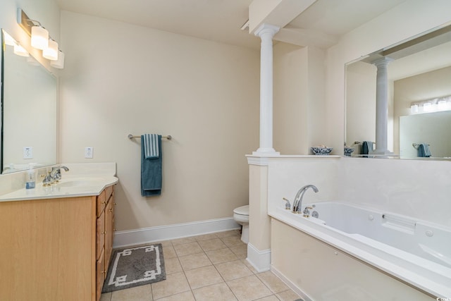 bathroom featuring a garden tub, decorative columns, tile patterned flooring, and vanity