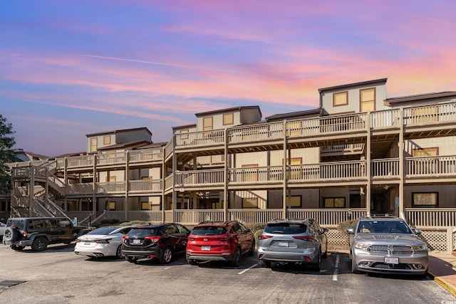 property at dusk with uncovered parking