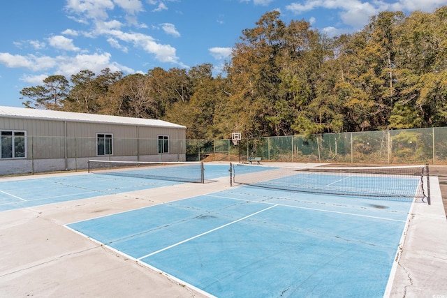 view of tennis court featuring fence