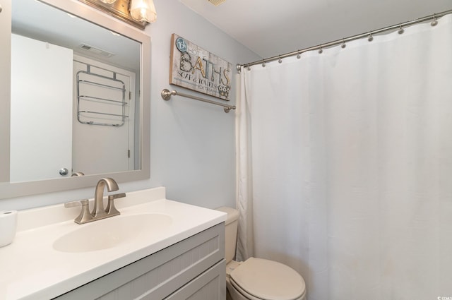 bathroom with visible vents, vanity, and toilet