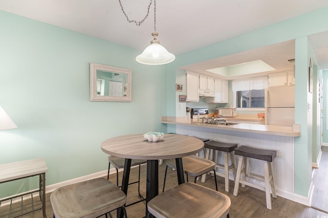 dining room featuring baseboards and wood finished floors