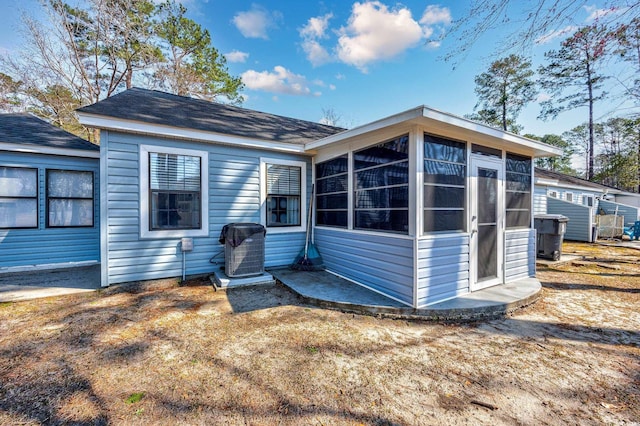 back of property featuring cooling unit and a sunroom