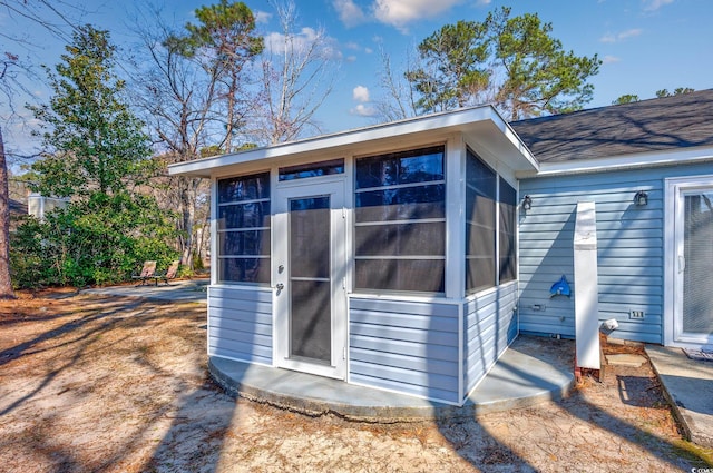 view of outbuilding with a sunroom