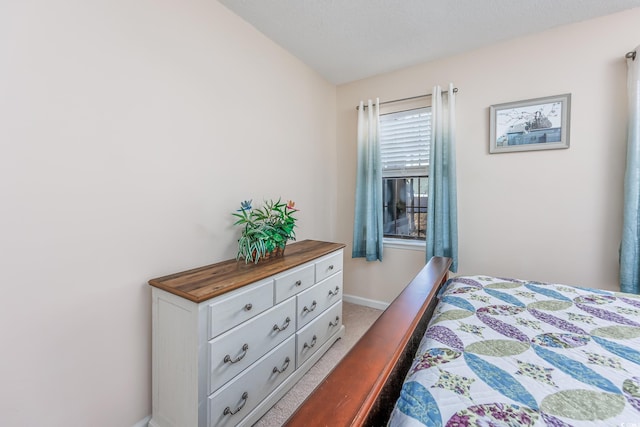 carpeted bedroom featuring baseboards