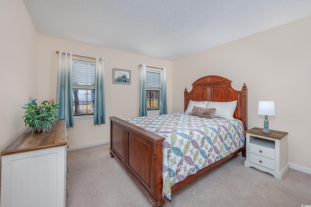 bedroom with a textured ceiling, baseboards, and light colored carpet