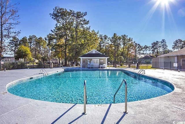 pool featuring a patio area and fence