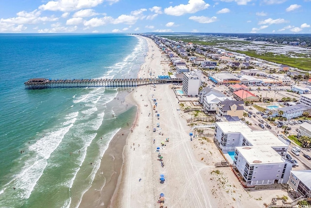 bird's eye view featuring a water view and a beach view