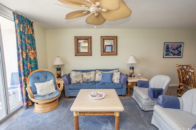 living room with a ceiling fan and a textured ceiling