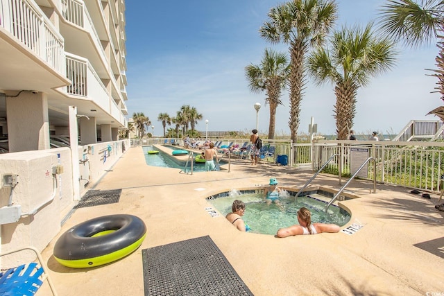 view of swimming pool with a patio and a hot tub