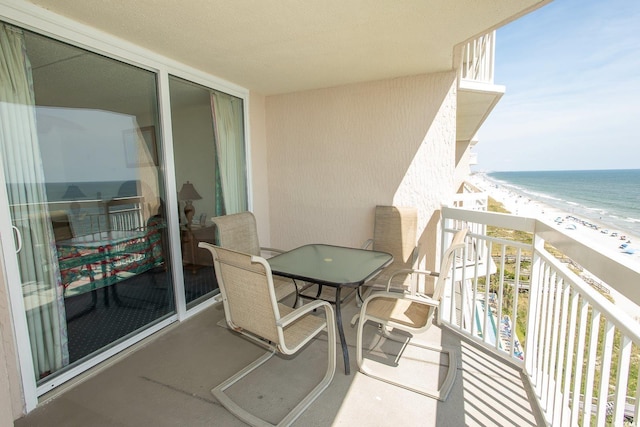 balcony with a beach view and a water view