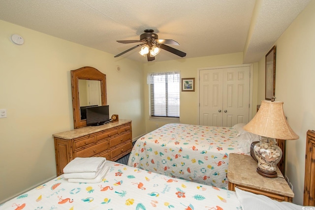 bedroom with a closet, ceiling fan, and a textured ceiling