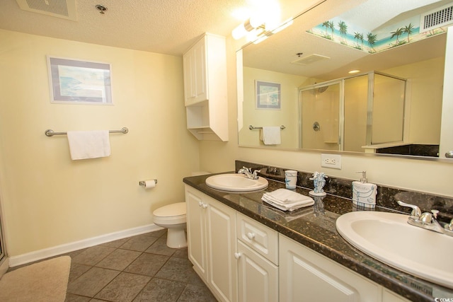 bathroom with a stall shower, visible vents, and a sink