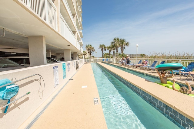 pool with a patio and fence