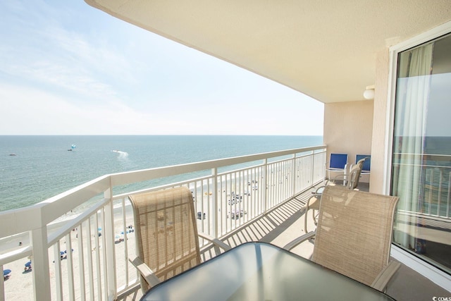 balcony with a water view and a beach view