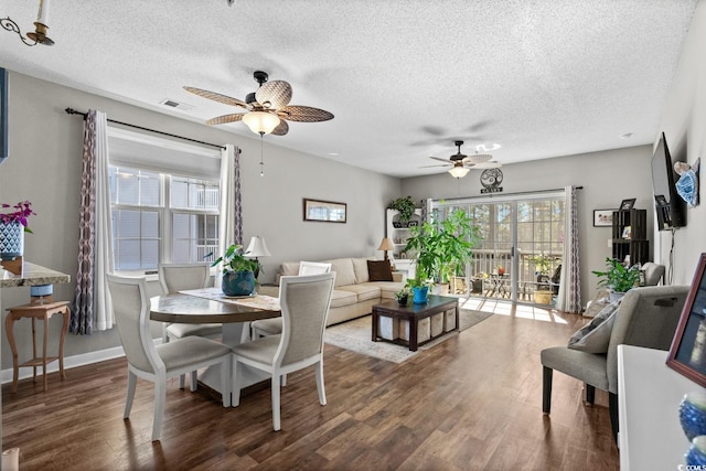 dining space with visible vents, a textured ceiling, and wood finished floors