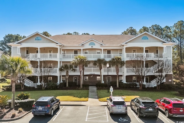 view of building exterior with uncovered parking