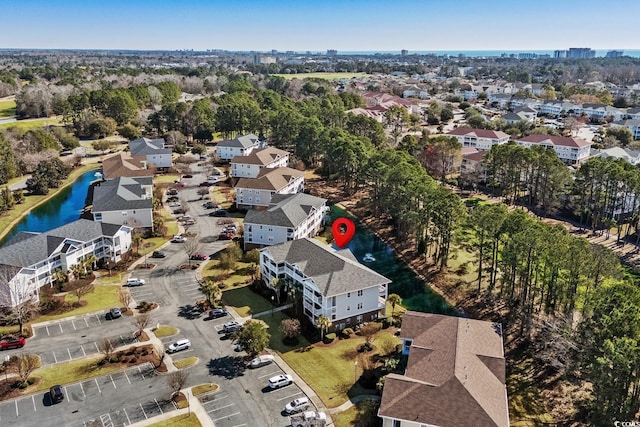 drone / aerial view with a water view and a residential view