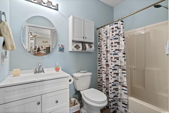 bathroom featuring shower / bath combo with shower curtain, vanity, toilet, and a ceiling fan