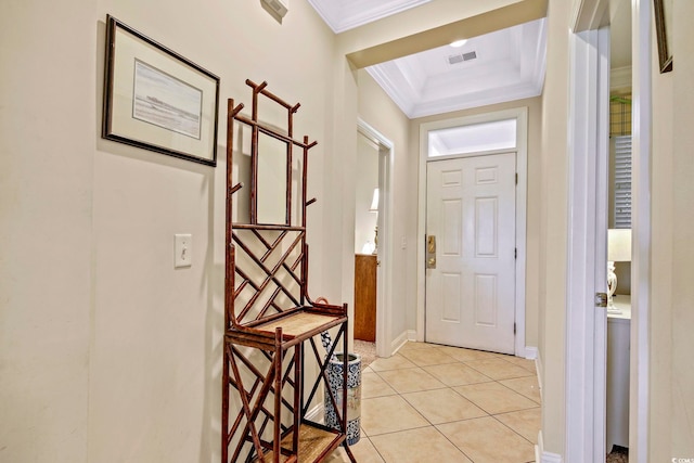 entryway featuring baseboards, light tile patterned flooring, visible vents, and crown molding