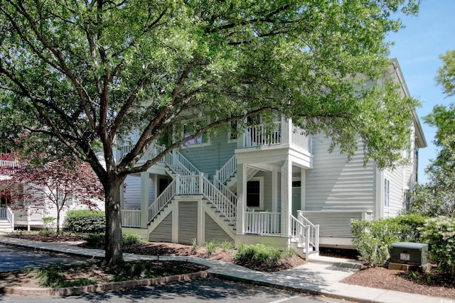 view of front of property with covered porch and stairs