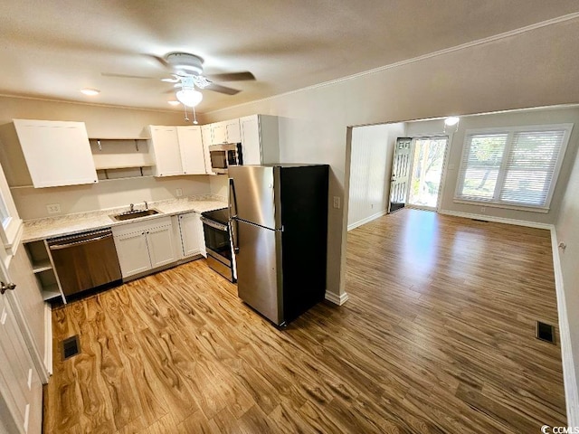 kitchen with visible vents, light wood-style flooring, appliances with stainless steel finishes, white cabinetry, and open shelves