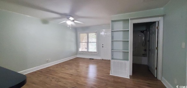 unfurnished bedroom with baseboards, visible vents, and dark wood finished floors