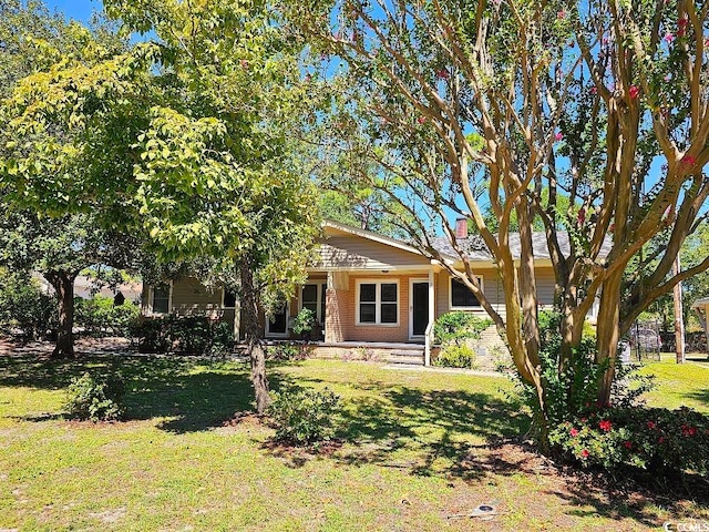 view of front of house featuring a front yard and brick siding