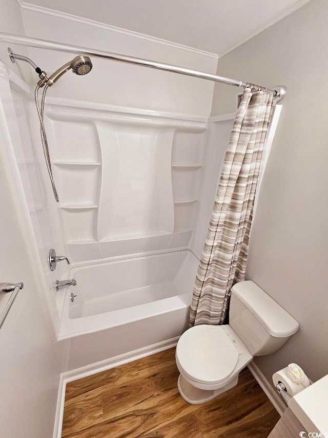 bathroom with ornamental molding, shower / bath combo with shower curtain, toilet, and wood finished floors