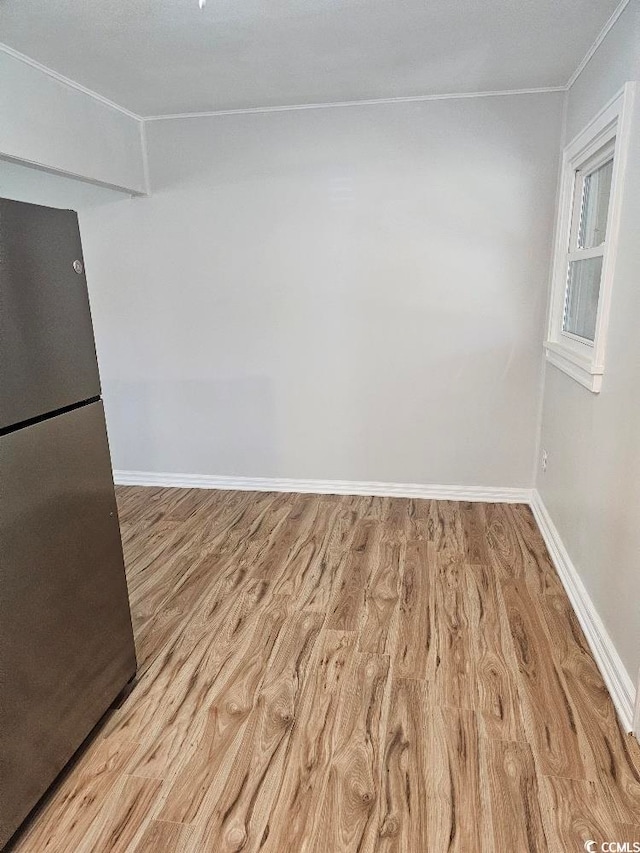 interior space with wood finished floors and baseboards