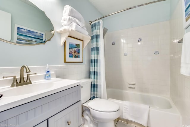 full bathroom with toilet, shower / tub combo, tile walls, and vanity