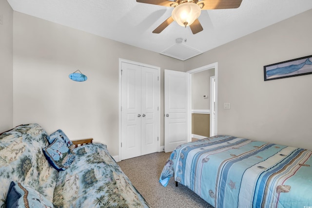 bedroom with carpet, attic access, ceiling fan, and a closet