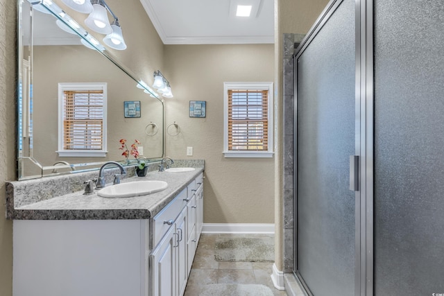 full bathroom with ornamental molding, a sink, a shower stall, and double vanity