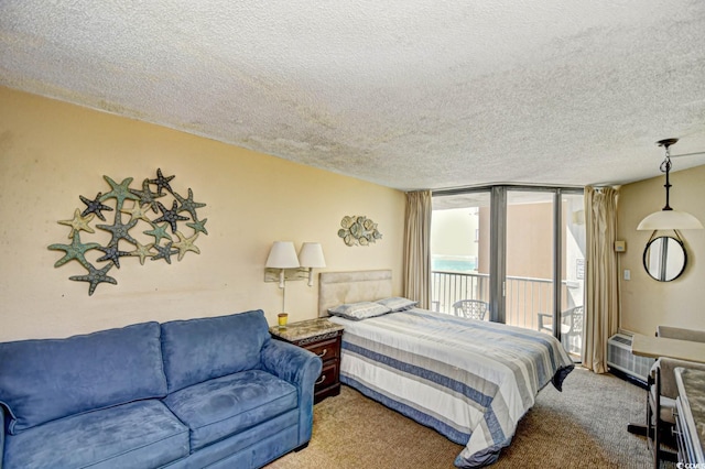 carpeted bedroom featuring a wall of windows, access to outside, and a textured ceiling