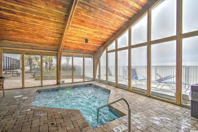 view of swimming pool with an indoor hot tub and a patio