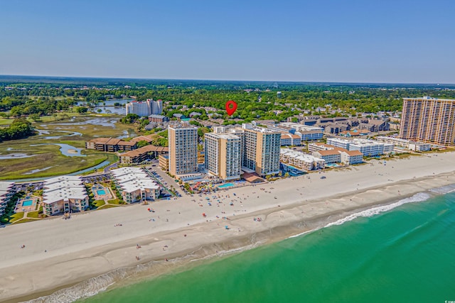 aerial view with a city view, a water view, and a beach view