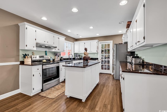 kitchen with dark wood-style floors, a center island, stainless steel appliances, under cabinet range hood, and white cabinetry