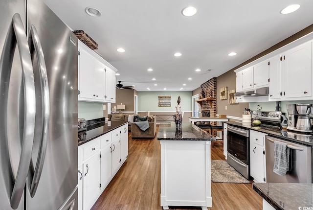 kitchen featuring light wood-type flooring, under cabinet range hood, appliances with stainless steel finishes, and recessed lighting