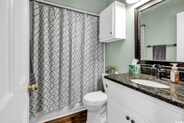 bathroom with wood finished floors, vanity, toilet, and shower / bathtub combination with curtain