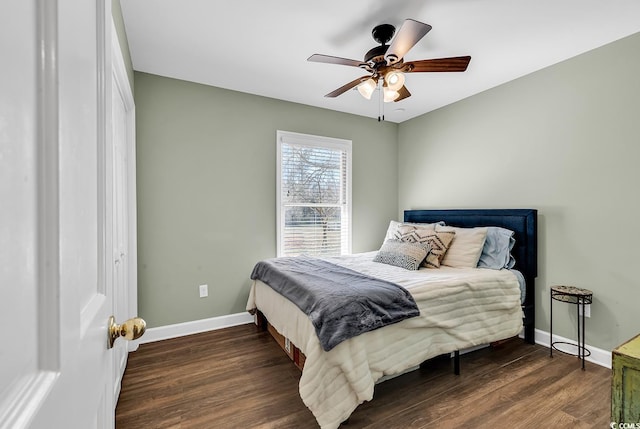 bedroom featuring wood finished floors, a ceiling fan, and baseboards