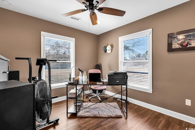 office with baseboards, wood finished floors, visible vents, and a ceiling fan