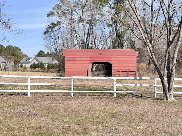 view of pole building featuring fence