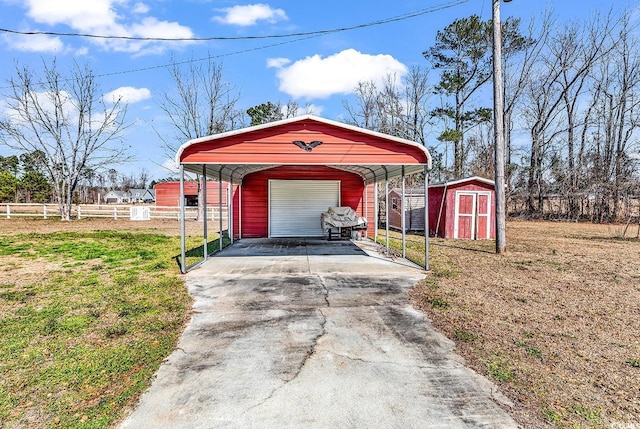 view of shed featuring driveway and fence