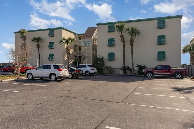 view of building exterior with uncovered parking