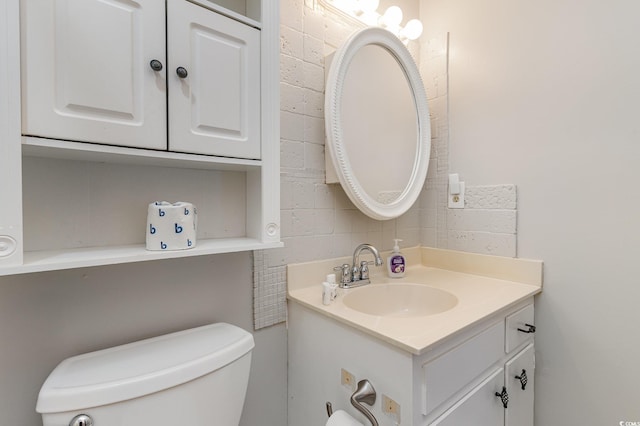 bathroom featuring toilet and vanity