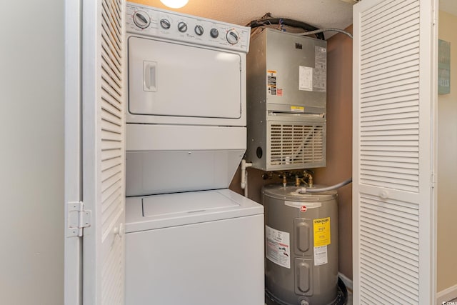 laundry area with water heater, laundry area, and stacked washer and dryer