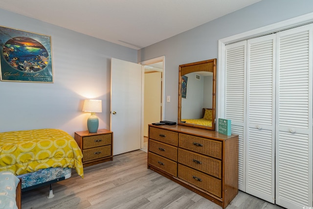 bedroom featuring a closet and light wood-type flooring