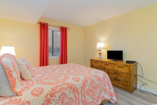 bedroom featuring light wood-style flooring and baseboards