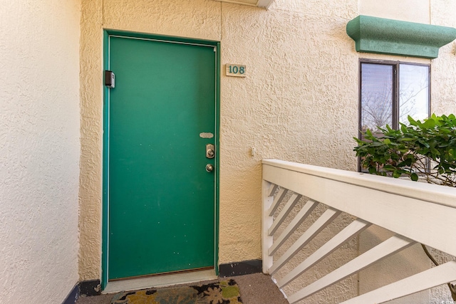 doorway to property with stucco siding